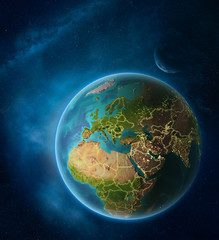 Planet Earth with highlighted Cyprus in space with Moon and Milky Way. Visible city lights and country borders.