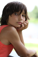 background. handsome guy in an orange t-shirt, leaned face to hand