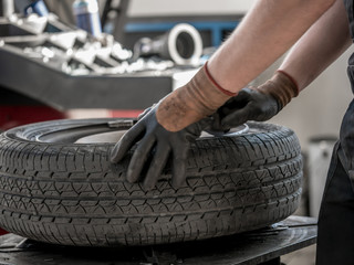 Wheel whit summer tire on tire changing machine in a workshop. Wheel on tire changing machine.