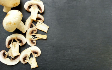 Sliced mushrooms on black background with empty space