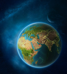 Obraz na płótnie Canvas Planet Earth with highlighted United Arab Emirates in space with Moon and Milky Way. Visible city lights and country borders.