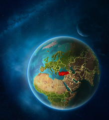 Planet Earth with highlighted Turkey in space with Moon and Milky Way. Visible city lights and country borders.