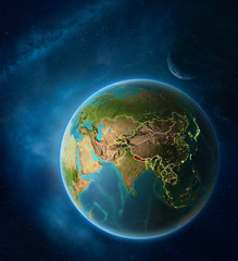 Planet Earth with highlighted Nepal in space with Moon and Milky Way. Visible city lights and country borders.