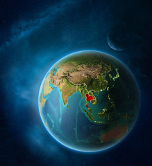 Planet Earth with highlighted Thailand in space with Moon and Milky Way. Visible city lights and country borders.