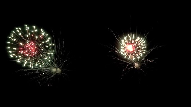 Bright colorful fireworks turn to multicolor bokeh lights at holiday dark summer night.
