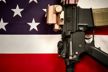 top view of a machine gun set against the background of the USA flag