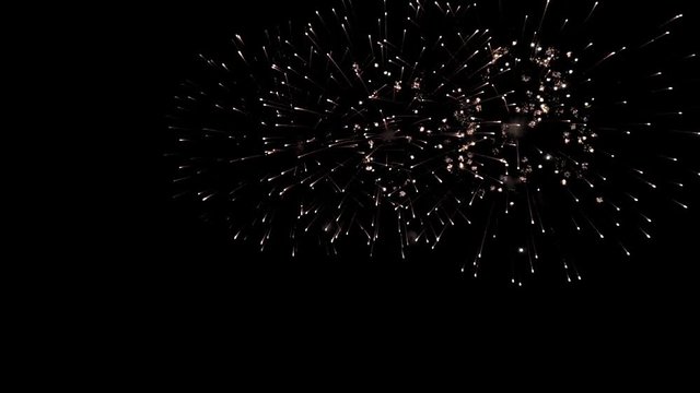 Bright colorful fireworks turn to multicolor bokeh lights at holiday dark summer night.