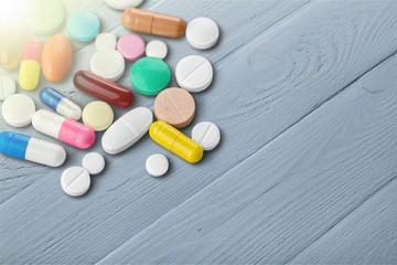 Colorful pills and tablets on background