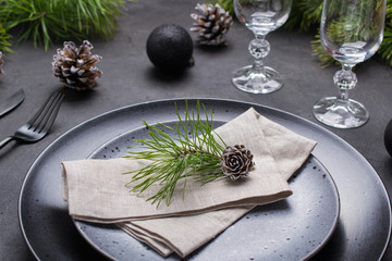 Christmas or New Year table setting. Place setting for Christmas Dinner. Holiday Decorations. Dark mood