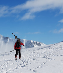 Fototapeta na wymiar Skier with skis go up to top of mountain