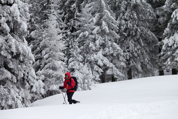 Hiker makes his way on slope with new-fallen snow