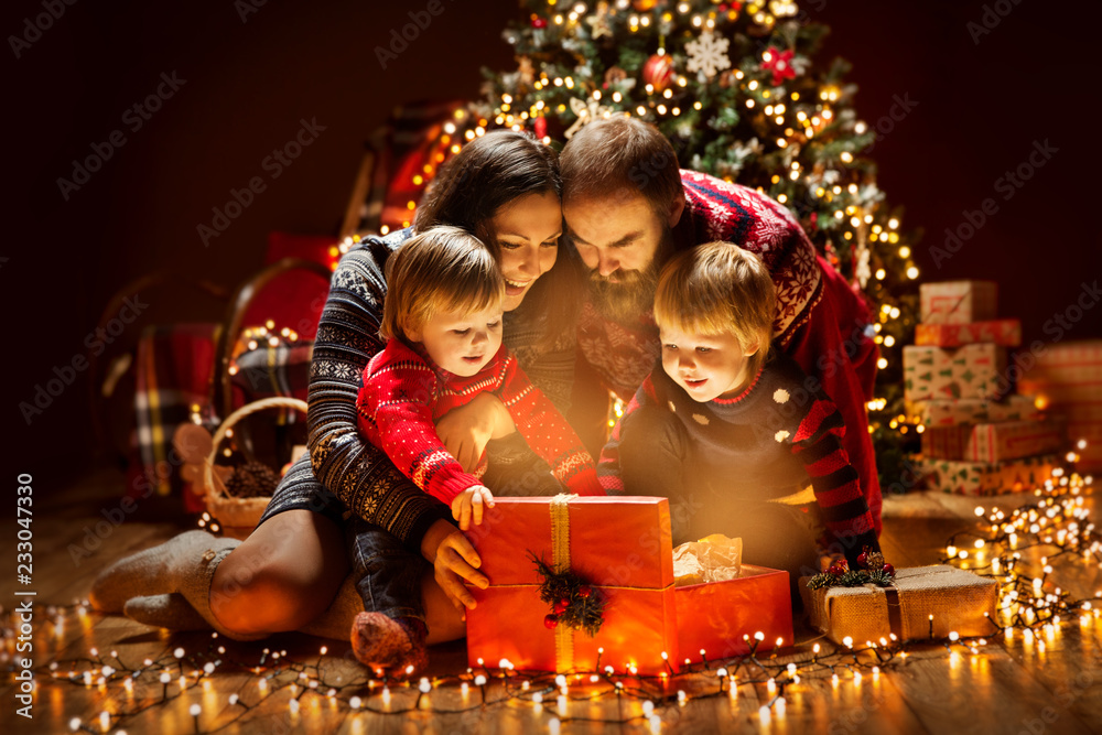 Wall mural Christmas Family open Lighting Present Gift Box under Xmas Tree, Happy Mother Father Children in Magic Night