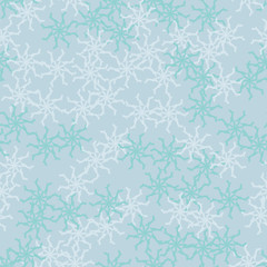 Winter seamless pattern with chaotic snowflakes in different shades of blue color
