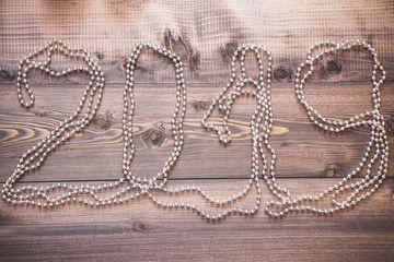 New Year's decor and festive toys on a wooden table.