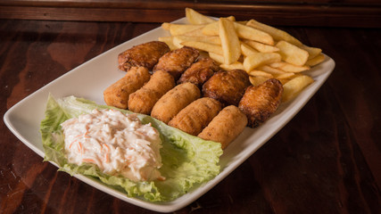 Croquettes with chips and surimi salad