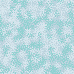 Winter seamless pattern with chaotic snowflakes in different shades of blue color