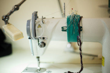 seamstress workplace. Sewing machine scissors threads and other tools. Tailoring industry