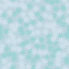 Winter seamless pattern with chaotic snowflakes in different shades of blue color