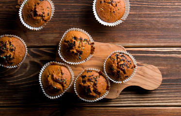 Delicious homemade muffins on wood.