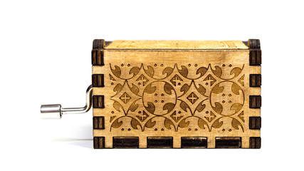 Back view of music box on white background. Macro of the music box with intricate patterns and texture.