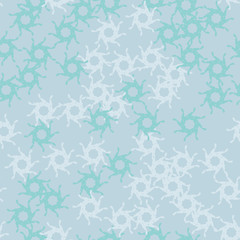 Winter seamless pattern with chaotic snowflakes in different shades of blue color