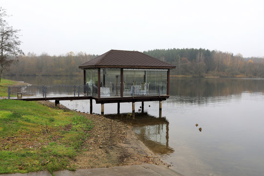 Pavilion on bank of lake in morning