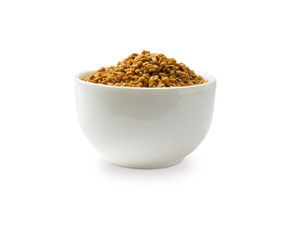 Fenugreek seeds in a wooden bowl isolated on white. Fenugreek seeds isolated on white background. Fenugreek with copy space for text.