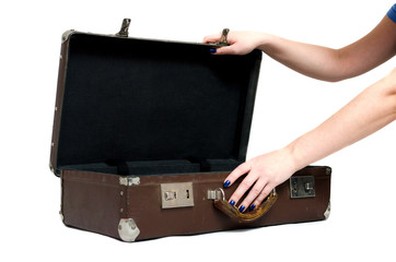 Retro suitcase and female hands isolated on the white background.
