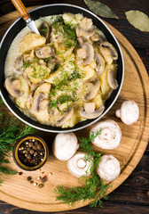 potatoes with mushrooms in a wooden frame