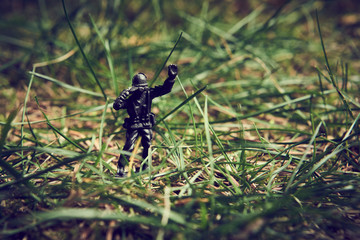 Soldiers in jungle fighting. Concept image of toy plastic soldiers in real grass.  Selective focus.