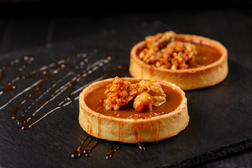 Homemade tart  with dark chocolate on a dark background