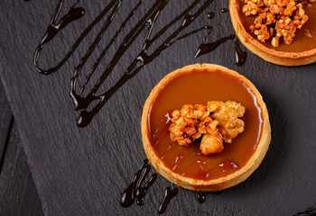 Homemade tart  with dark chocolate on a dark background