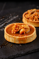 Homemade tart  with dark chocolate on a dark background