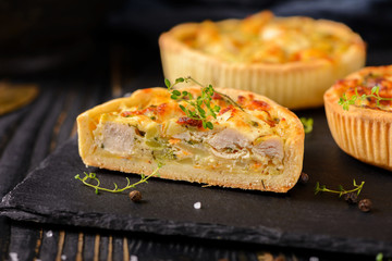 Meat mini pie on the wooden board on table background, closeup with copy space, rustic style