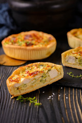 Meat mini pie on the wooden board on table background, closeup with copy space, rustic style