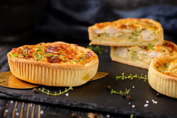 Meat mini pie on the wooden board on table background, closeup with copy space, rustic style