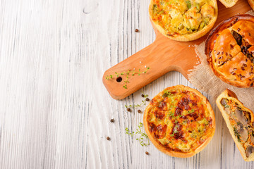 Meat mini pie on the wooden board on white table background, closeup with copy space, rustic style