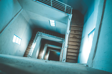 Concrete staircase in a high tower with many steps