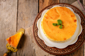 Homemade round cheesecake with mint for dessert - healthy organic summer dessert pie cheesecake. Country style.