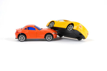 Fototapeta na wymiar Car accident concept. Yellow and red toy cars on a white background