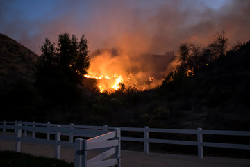 Fire Burning Hill Just Beyond White Park Fence in California Woolsey Brushfire