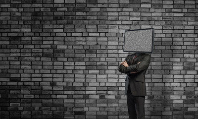 Businessman with TV instead of head.