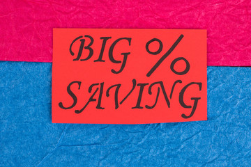 Red card with message big saving. Paper card with inscription big saving on colorful paper background. Shopping savings concept.