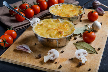 julienne with mushrooms on a wooden background
