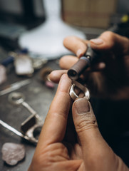 girl master processes the metal plate in the home workshop