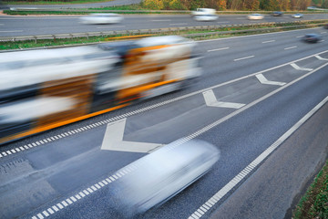 Fast moving vehicles at motion blur on the highway