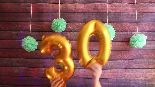 Happy thirty birthday with golden number 30 air balloons, anniversary celebration with decorations