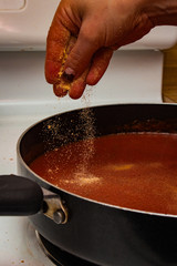 Sprinkling Garlic on Fresh Sauce