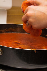 Placing Pepperoni in Pasta Sauce
