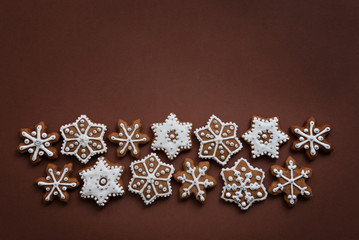 Christmas cookies in the shape of snowflakes handmade. Basic for your decoration on the brown background